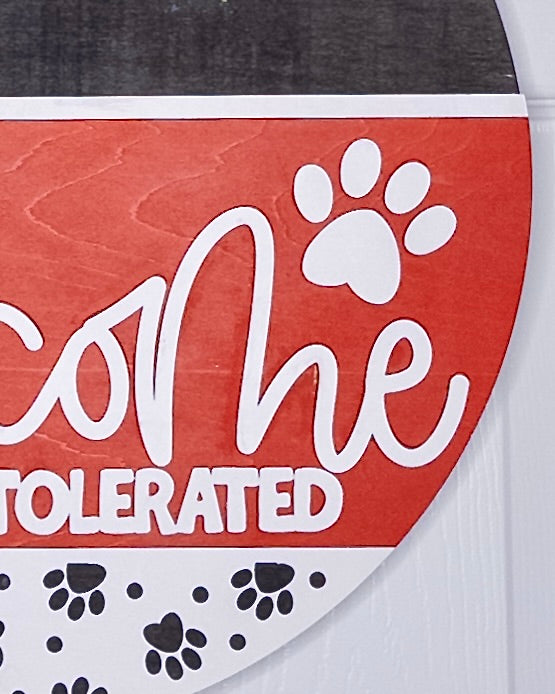 Product packaging with 'Welcome' and paw prints on a red background