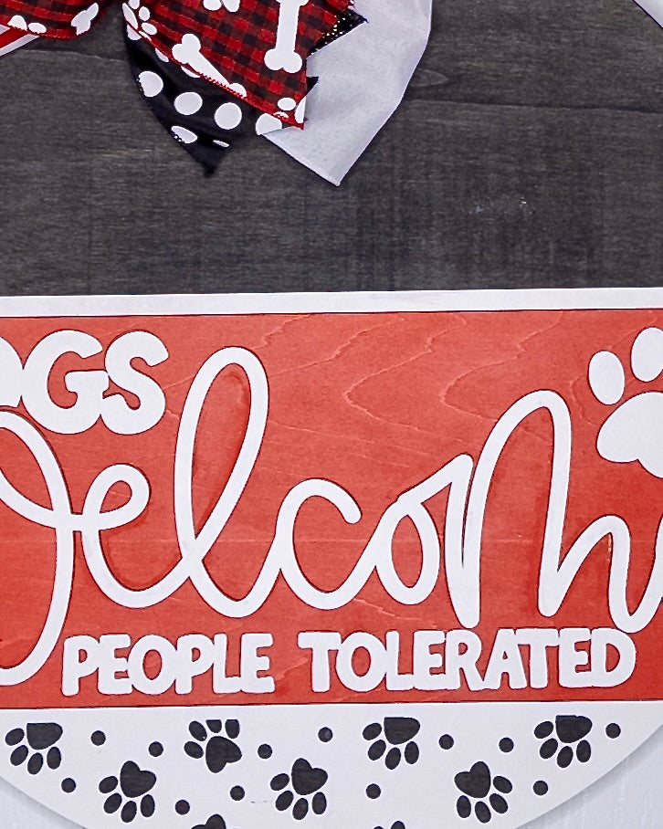 Dog bandana with text 'Dogs Welcome, People Tolerated' on a red background
