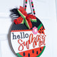 Decorative sign shaped like a watermelon with 'hello summer' text on a white background