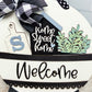 Decorative sign with 'Home Sweet Home' and 'Welcome' text, featuring a black and white checkered ribbon.