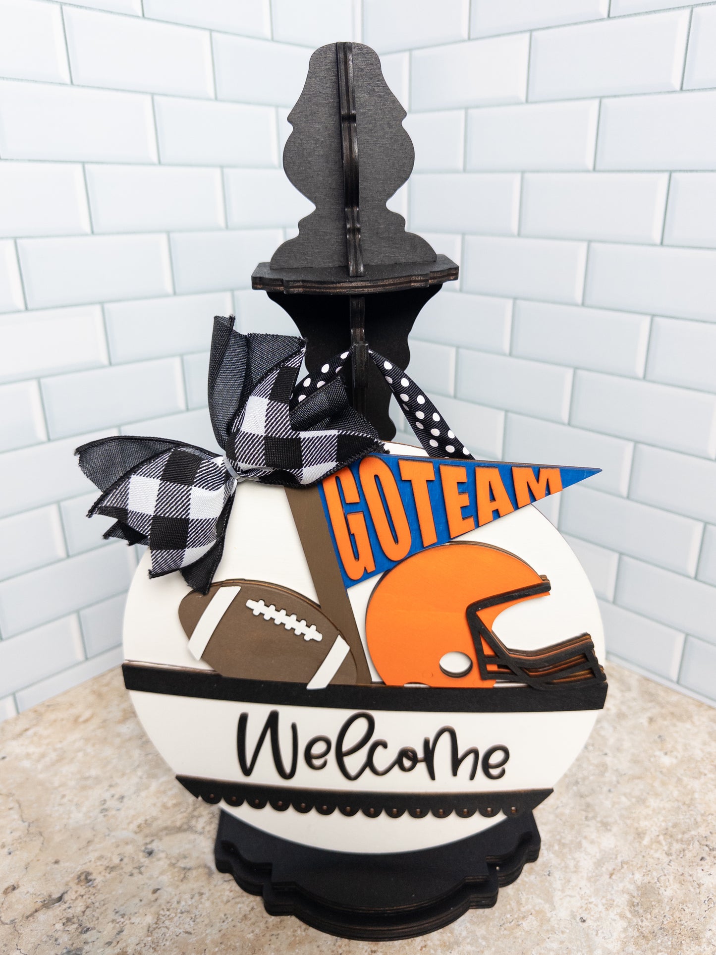 Decorative sign with sports-themed design and 'GOTeam' text on a white background.