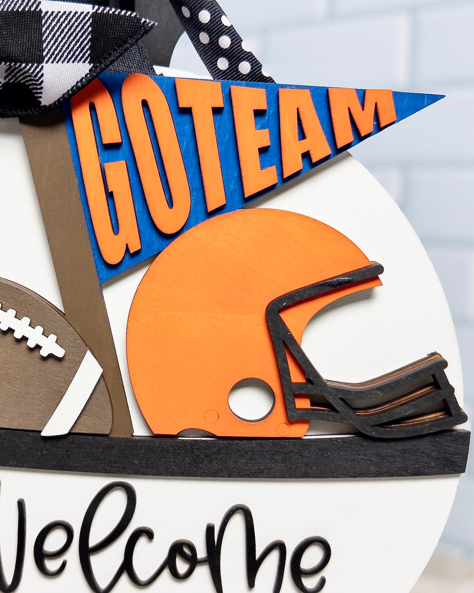 Decorative sign with football helmet, football, and 'GO TEAM' banner on a white background