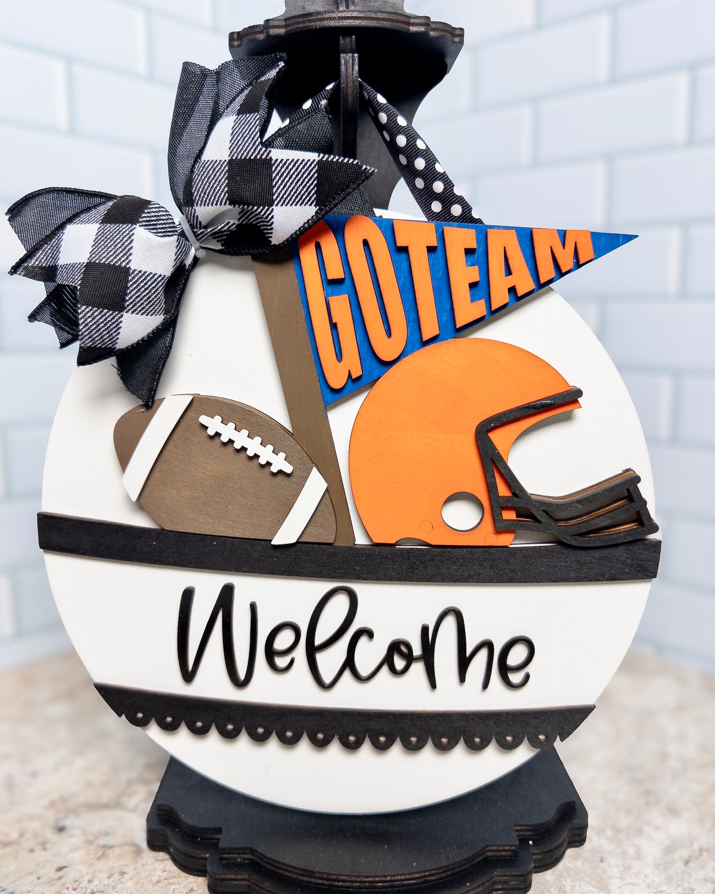 Decorative sign with football, helmet, and 'GOTeam' banner on a white background