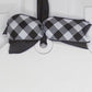 Black and white checkered bow on a white door