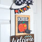 Decorative door hanger with 'School Welcome' text, apple illustration, and banner on a white background.