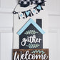 Decorative wooden sign with 'gather welcome' text on a white background