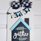 Decorative sign with 'gather' text, hearts, and a bow on a white background